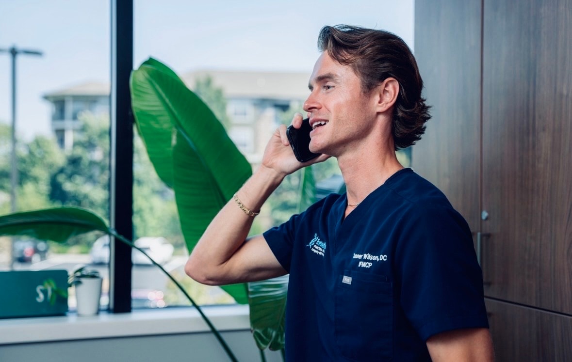 Tanner Wilson, DC, IFMCP on a phone consultation at EvoHealth in Overland Park