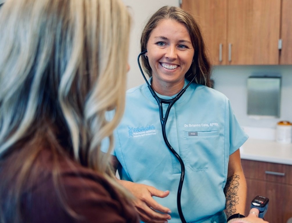 Brianna Cole, DNP, APRN, FNP-C with a patient during an assessment at EvoHealth in Overland Park