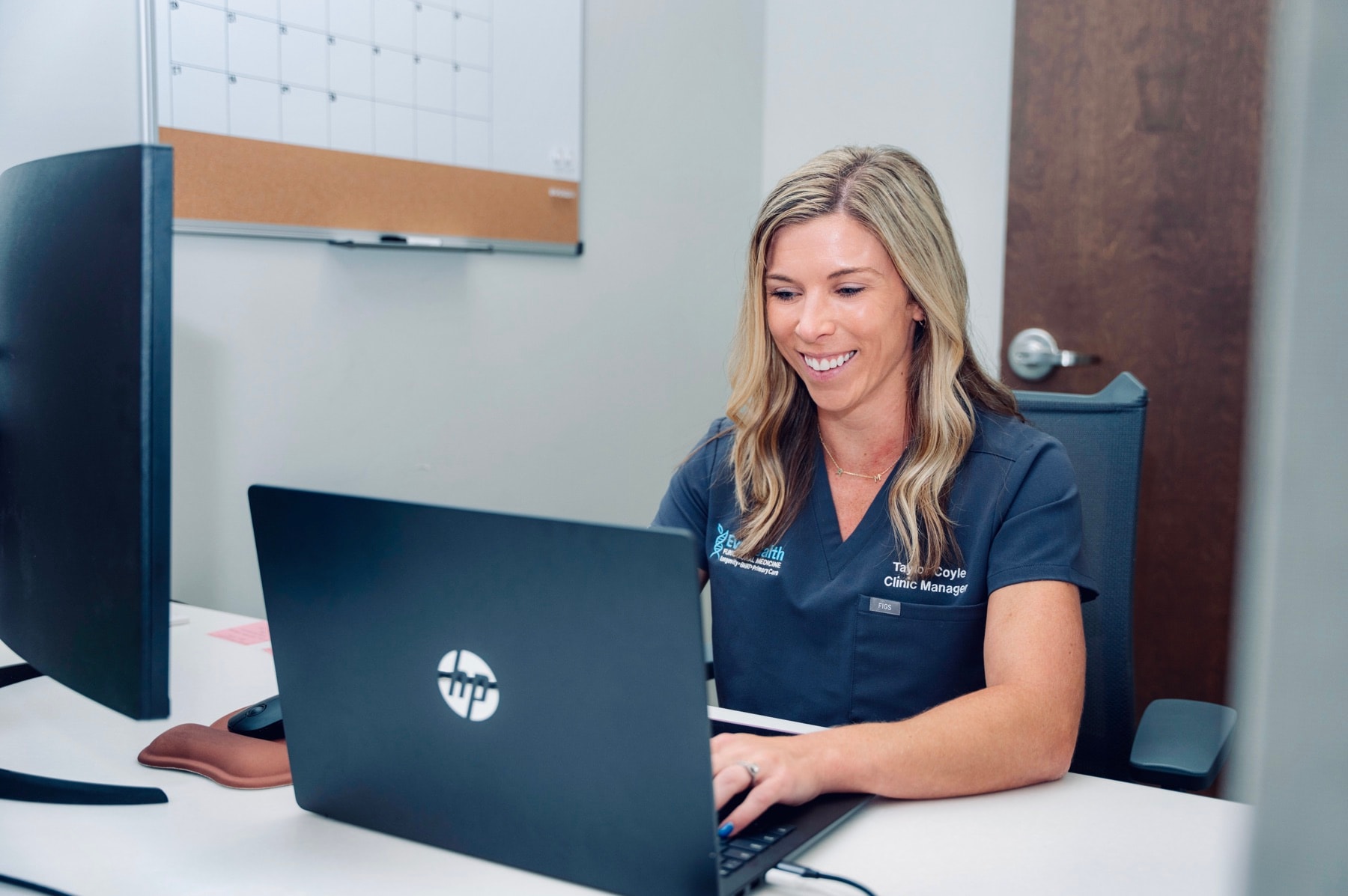 An EvoHealth team member reviewing patient records at the Overland Park office